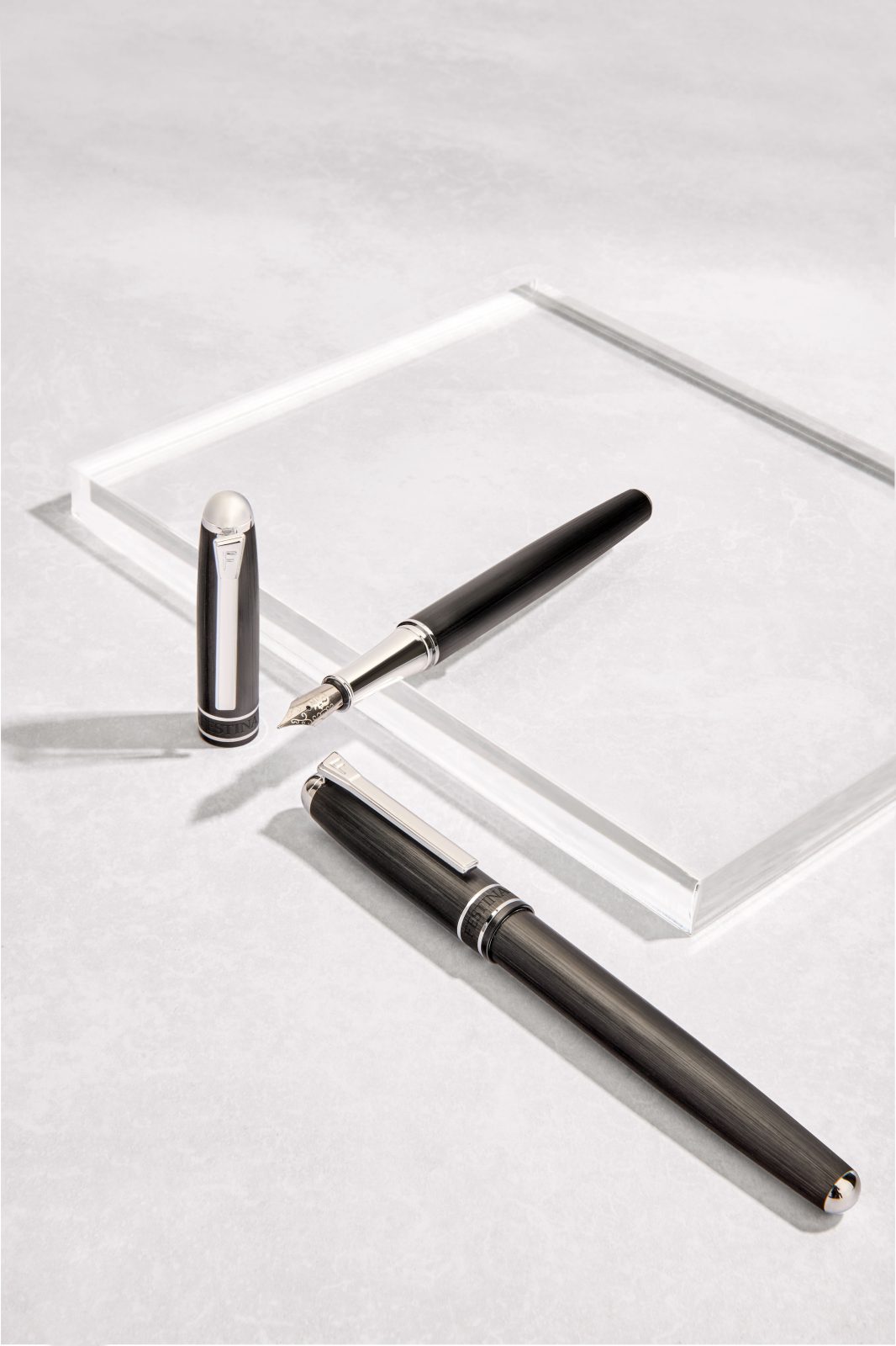 Writing instruments arranged on a glass tray — Festina